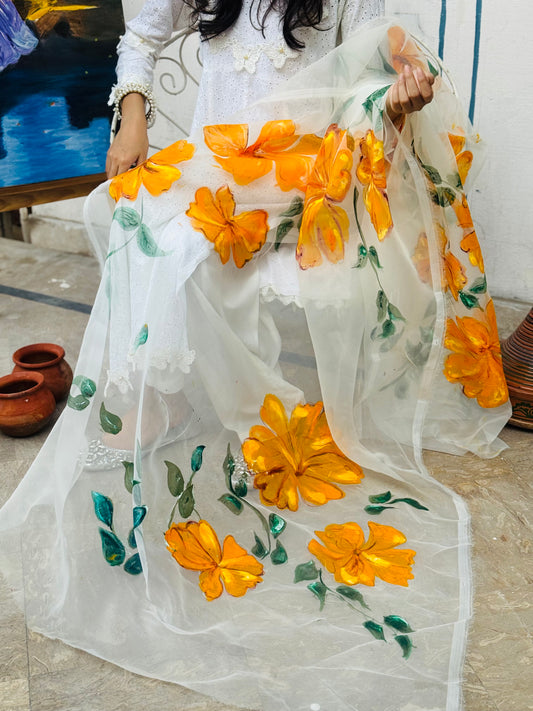 Close view of Mehr hand painted white organza dupatta featuring yellow flowers and green leaf artwork