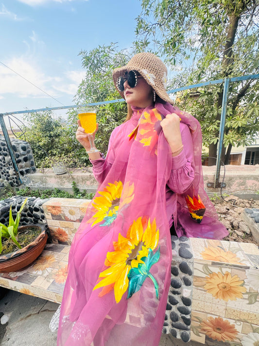 Woman styling Mukhi hand painted organza dupatta with bright sunflower floral design on pink base